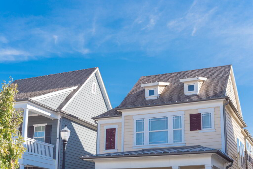 Close-up dormer roof windows on second story of house